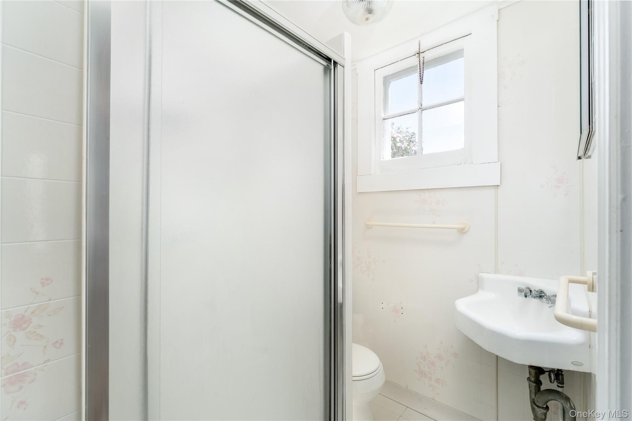 46 Rampasture Road, Unit 3 Hampton Bays, NY 11946 - Photo 14 of 29 a bathroom with a sink a toilet and shower