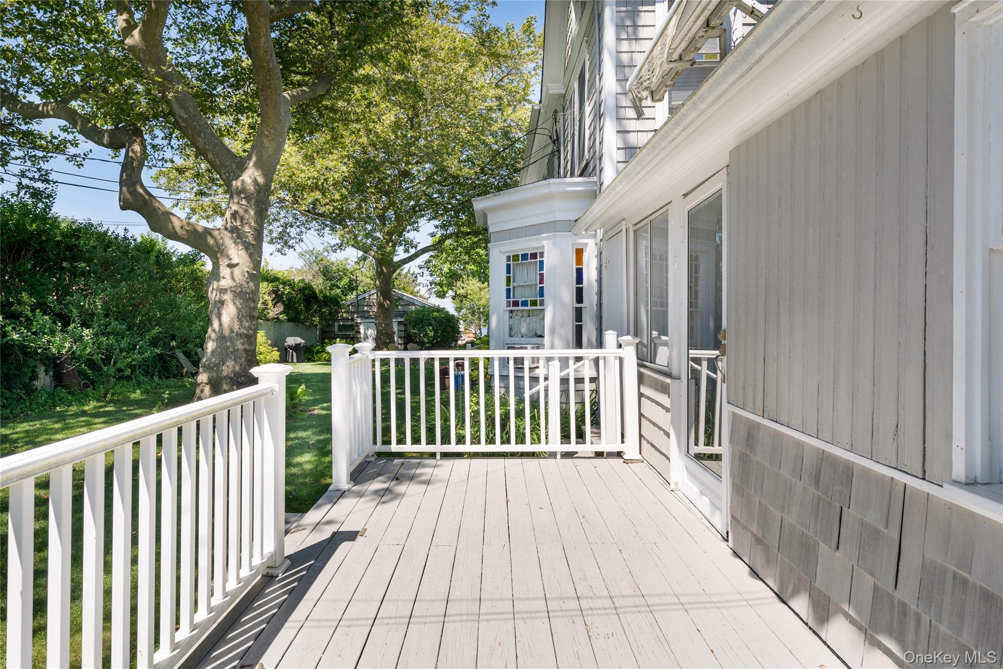 46 Rampasture Road, Unit 3 Hampton Bays, NY 11946 - Photo 15 of 29 a view of a wooden house with a bench