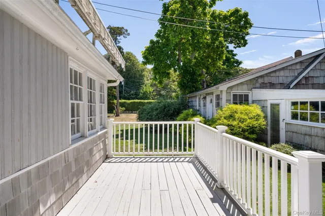 a view of a house with backyard and deck
