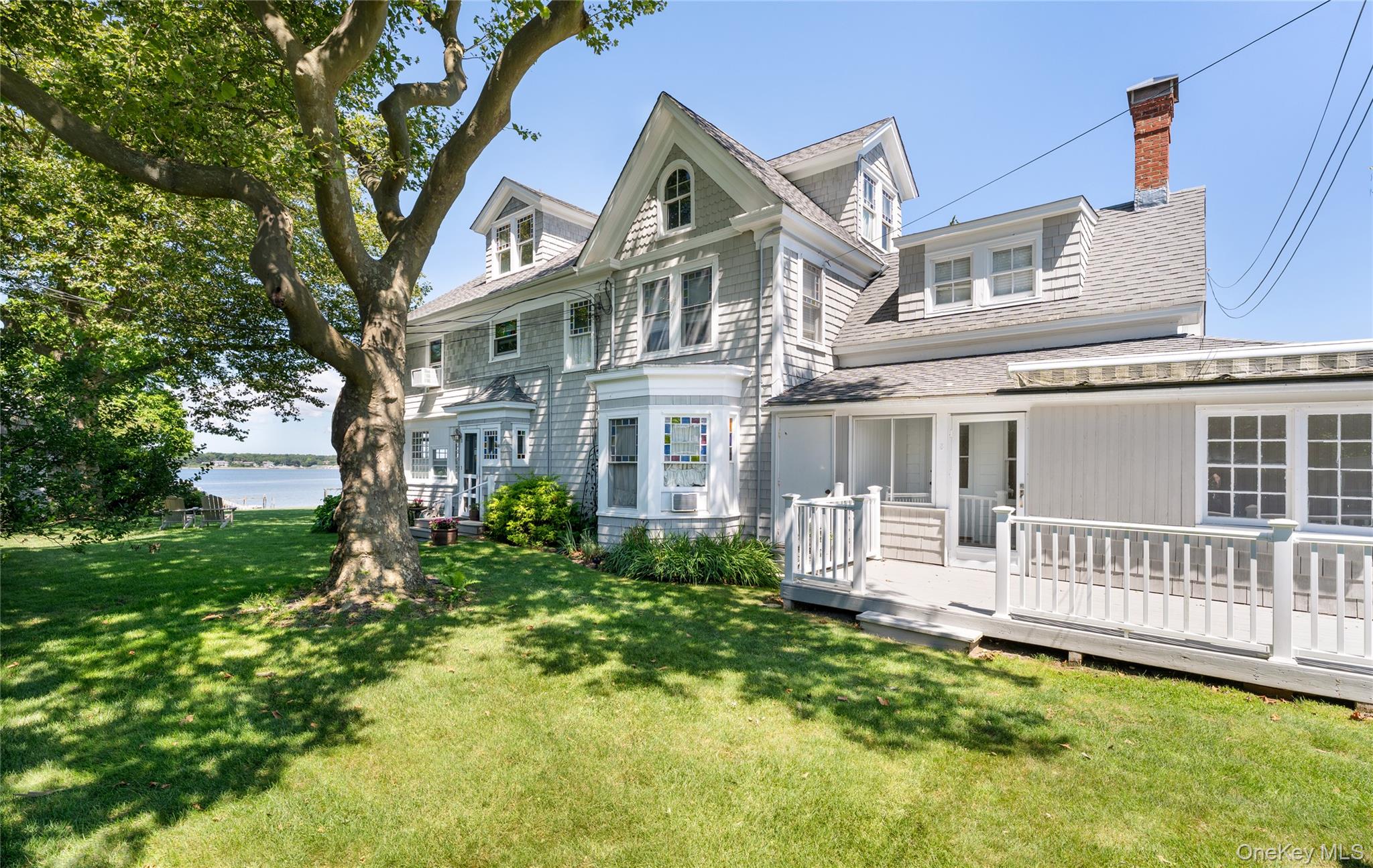 46 Rampasture Road, Unit 3 Hampton Bays, NY 11946 - Photo 18 of 29 a front view of a house with a garden
