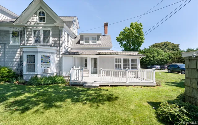 a front view of a house with a yard table and chairs
