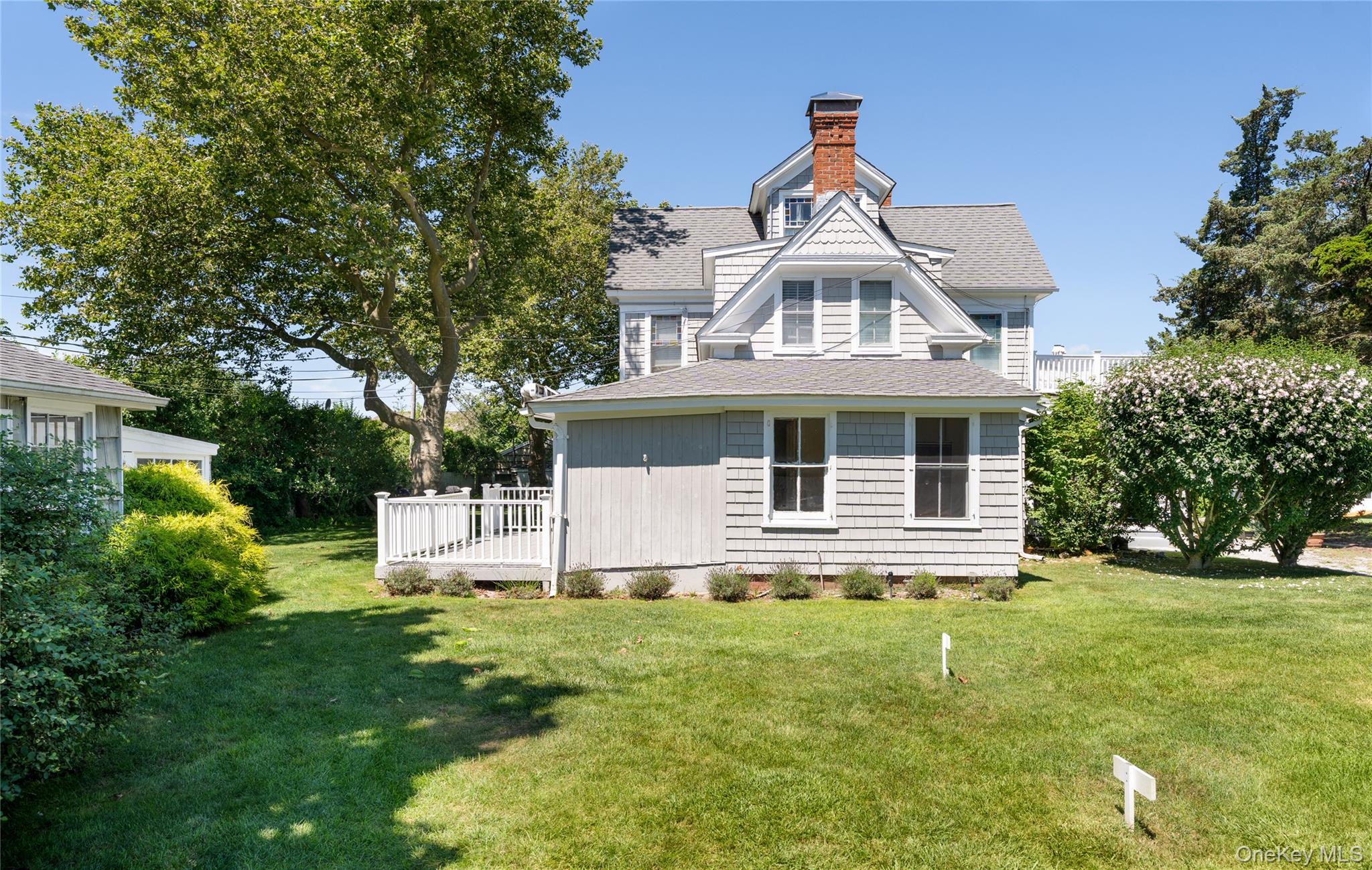 46 Rampasture Road, Unit 3 Hampton Bays, NY 11946 - Photo 22 of 29 a front view of a house with a yard