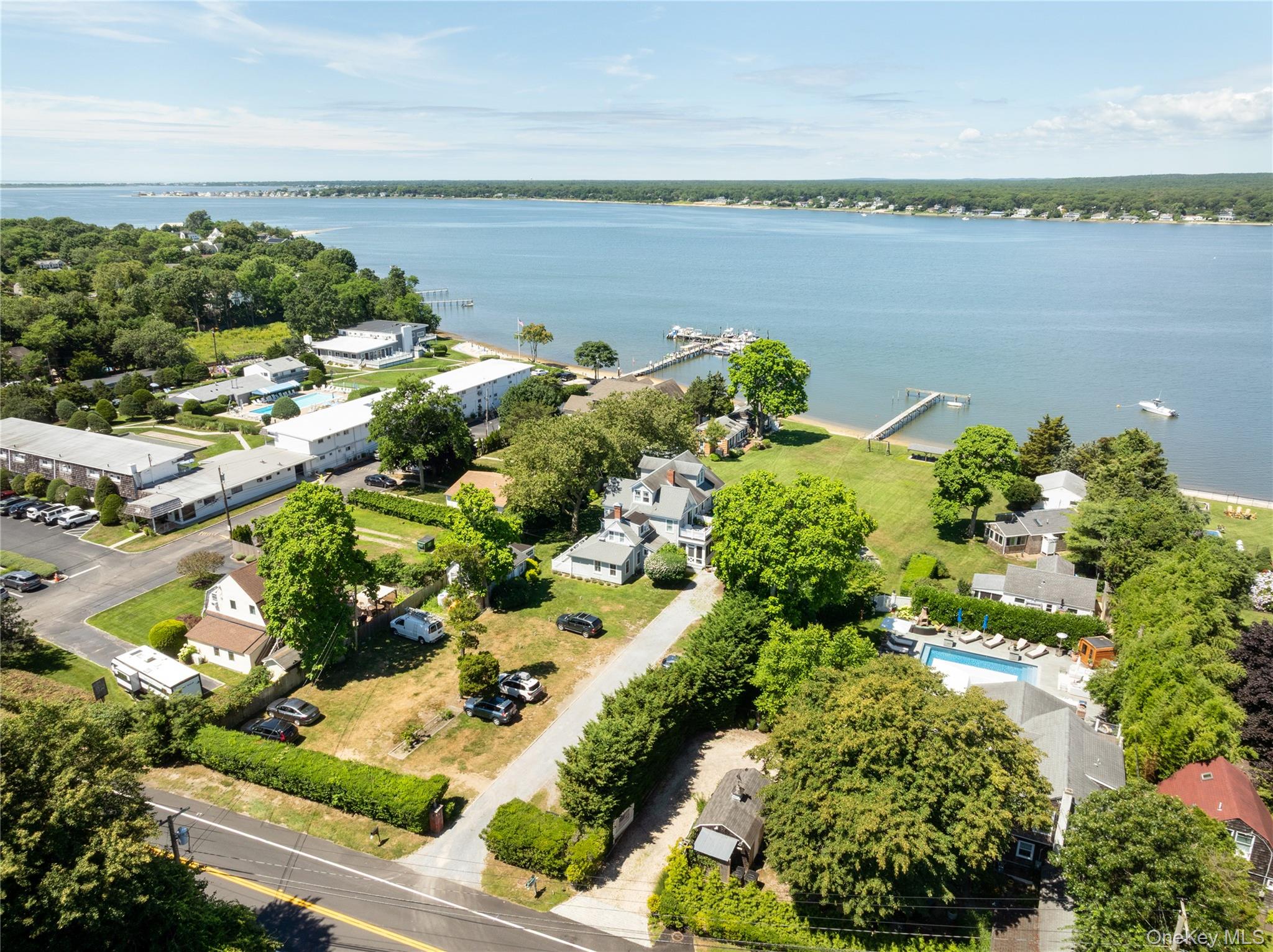 46 Rampasture Road, Unit 3 Hampton Bays, NY 11946 - Photo 27 of 29 a view of a lake with lawn chairs