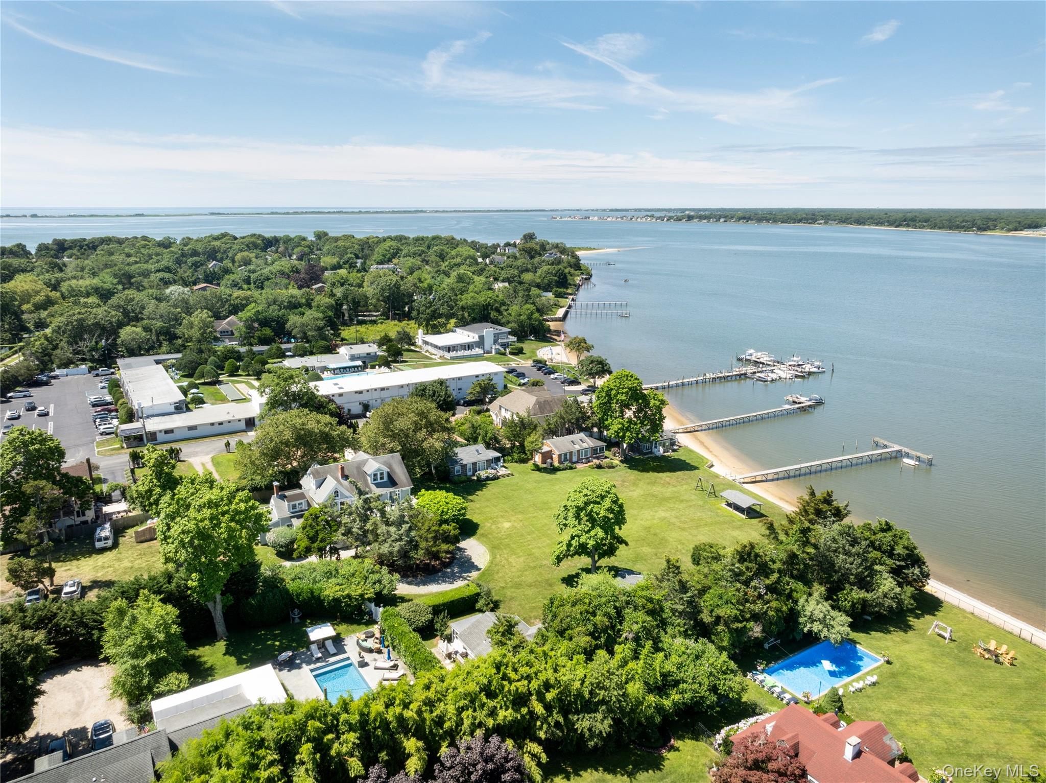 46 Rampasture Road, Unit 3 Hampton Bays, NY 11946 - Photo 28 of 29 a view of a house with a lot of plants and trees in front of it