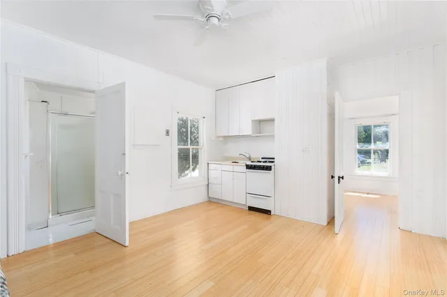 a kitchen with granite countertop a refrigerator and a stove top oven