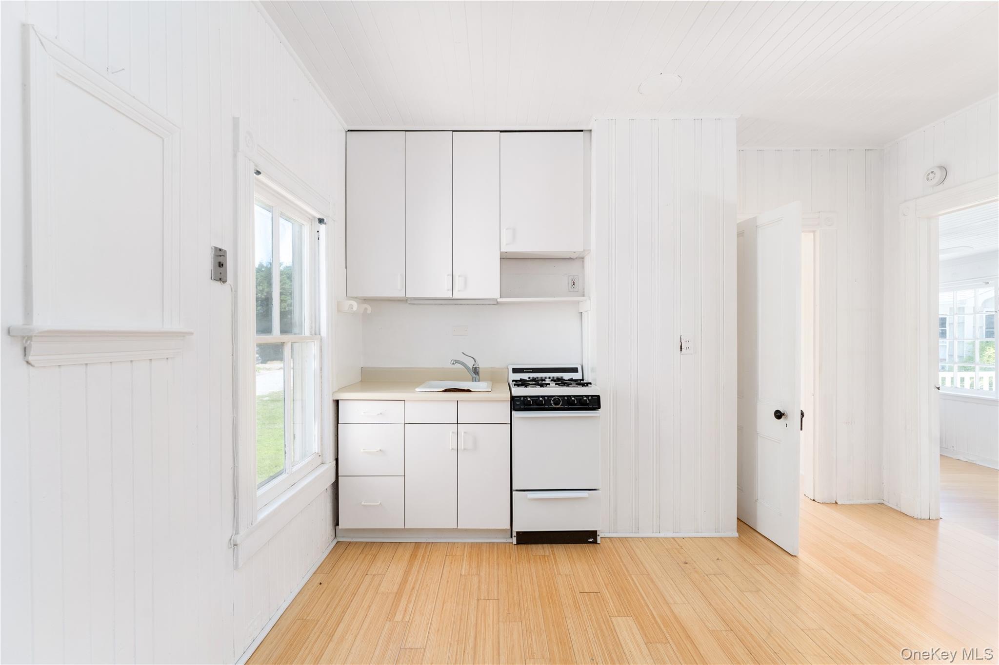 46 Rampasture Road, Unit 3 Hampton Bays, NY 11946 - Photo 9 of 29 a kitchen with stainless steel appliances a refrigerator and a stove