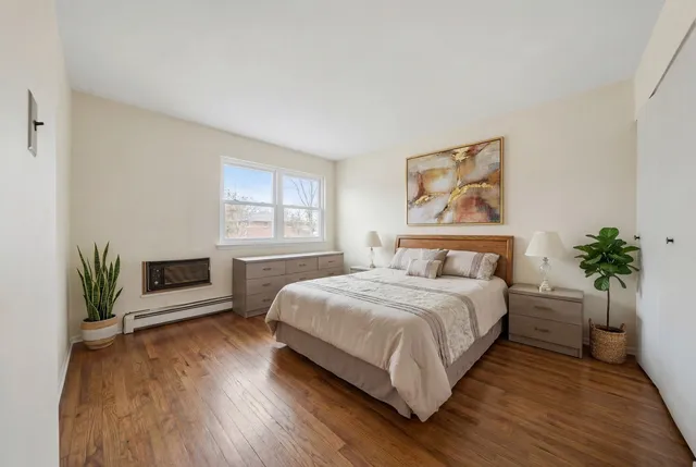 a kitchen with a sink a refrigerator and white cabinets