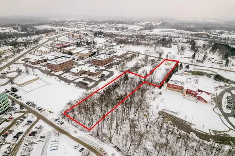 an aerial view of a house with a yard and lake view