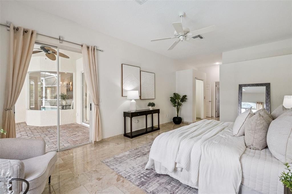 2541 Teton Stone Run Orlando, FL 32828 - Photo 10 of 82 a bedroom with a large bed and a chandelier
