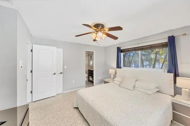 a bedroom with a large bed and a window