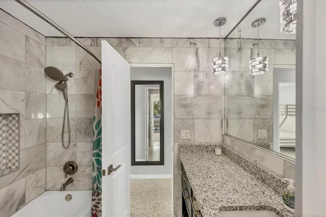 a bathroom with a shower and a sink