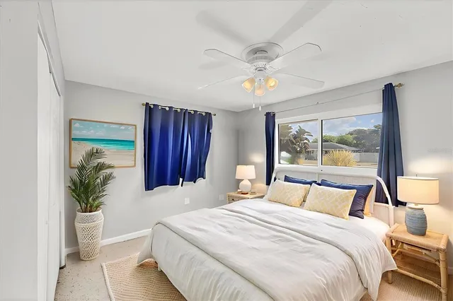 a bedroom with a large bed and a chandelier