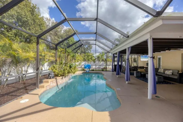 a view of a patio with a table and chairs under an umbrella