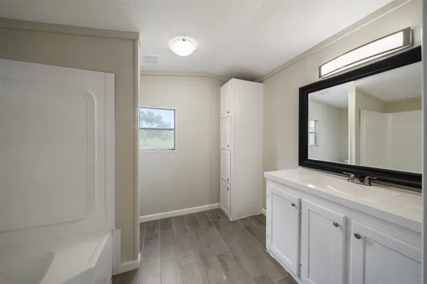 a bathroom with a sink a mirror and a shower