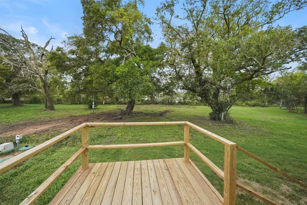 a view of deck with a large trees