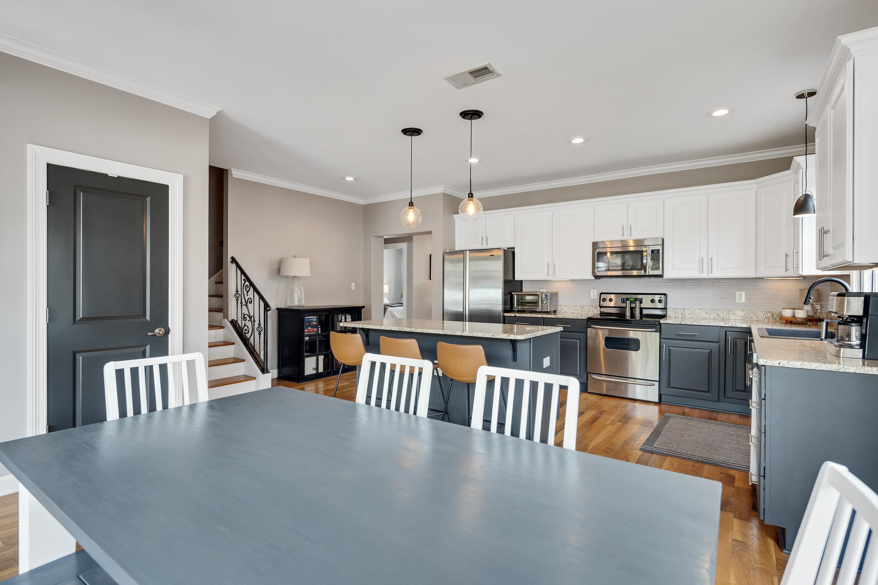 808 Deloach Lane Collierville, TN 38017 - Photo 13 of 40 an open kitchen with stainless steel appliances granite countertop a stove top oven a sink a dining table and chairs