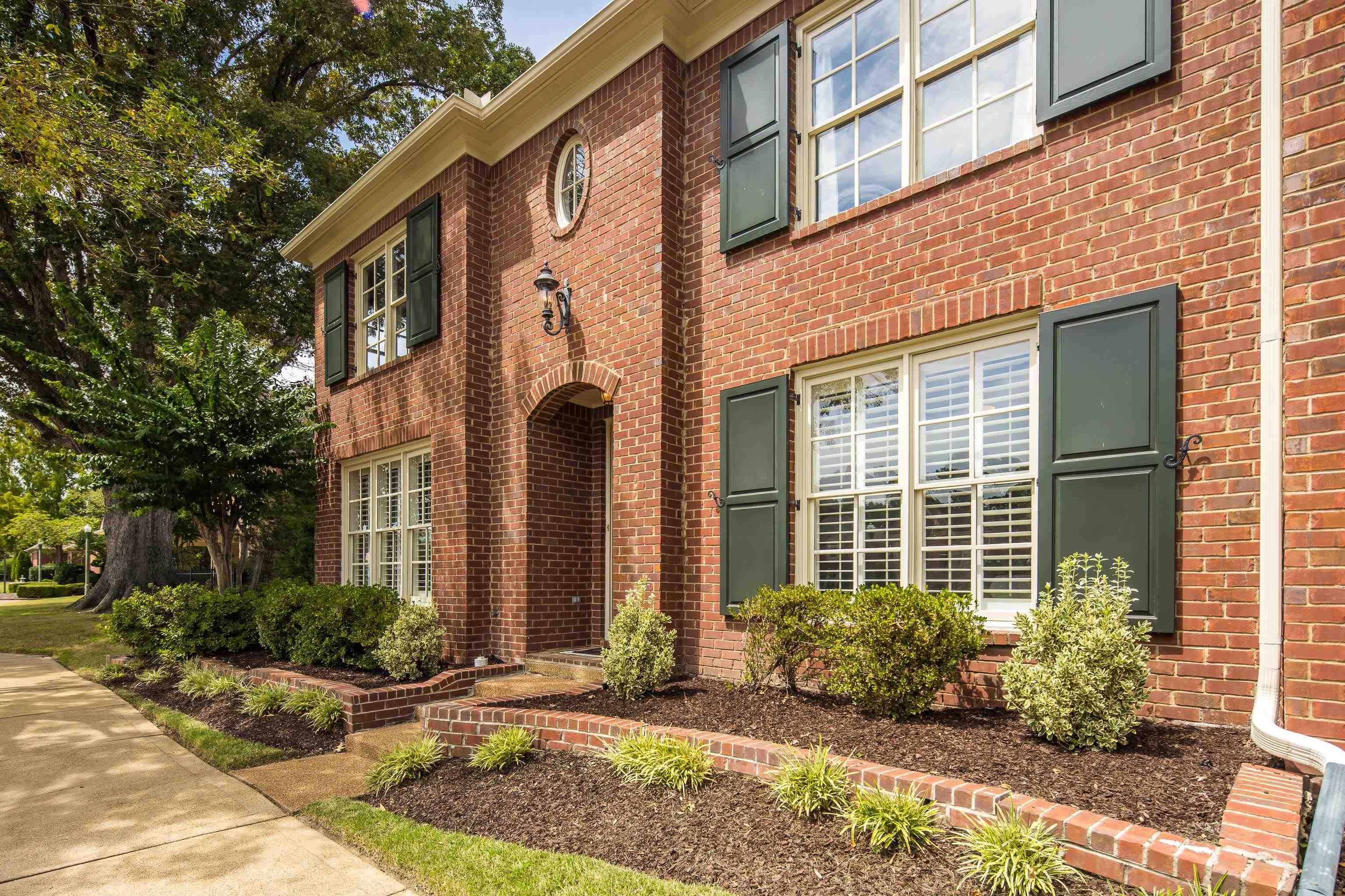 808 Deloach Lane Collierville, TN 38017 - Photo 3 of 40 a view of a brick building with potted plants