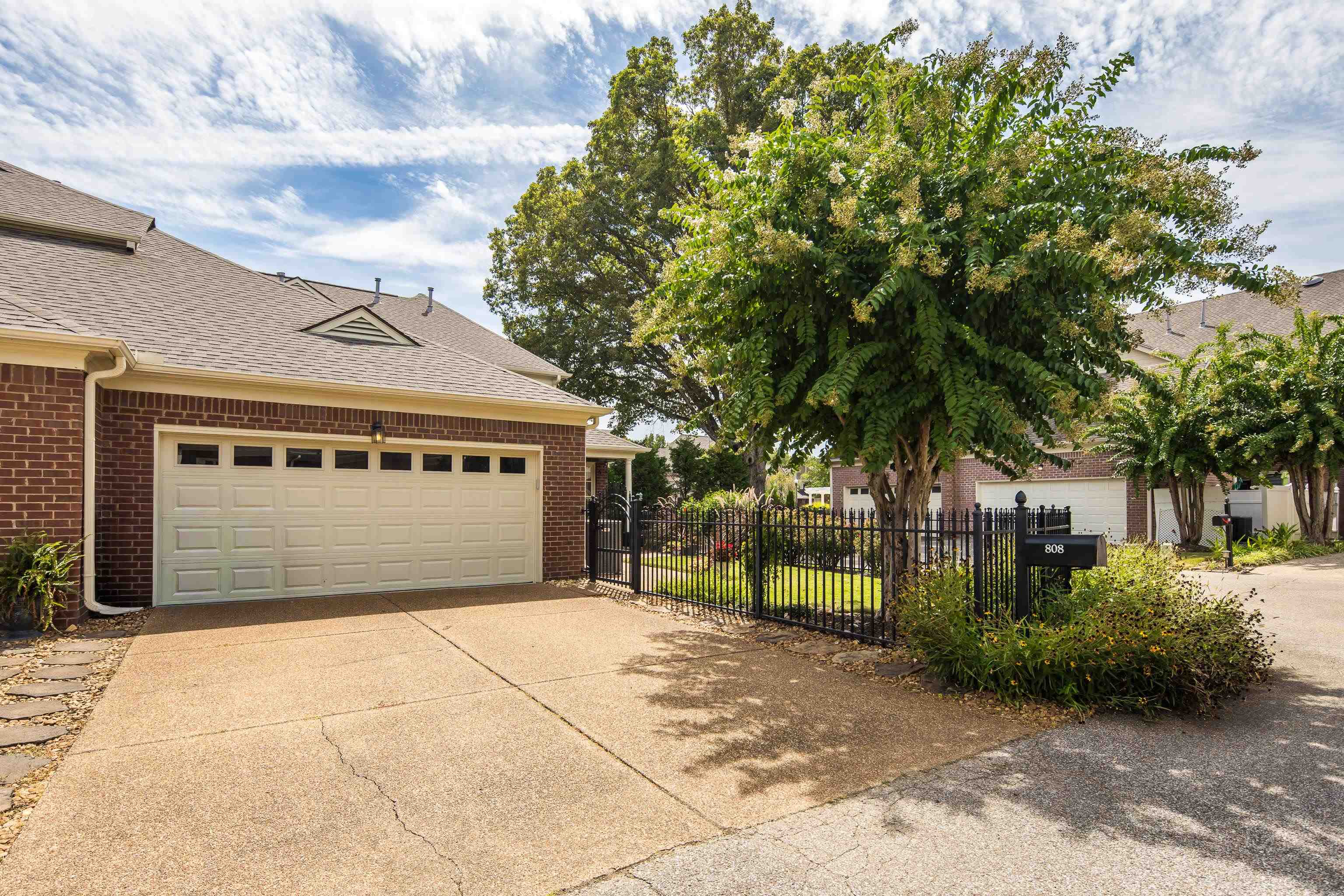808 Deloach Lane Collierville, TN 38017 - Photo 35 of 40 a front view of a house with a garden and trees