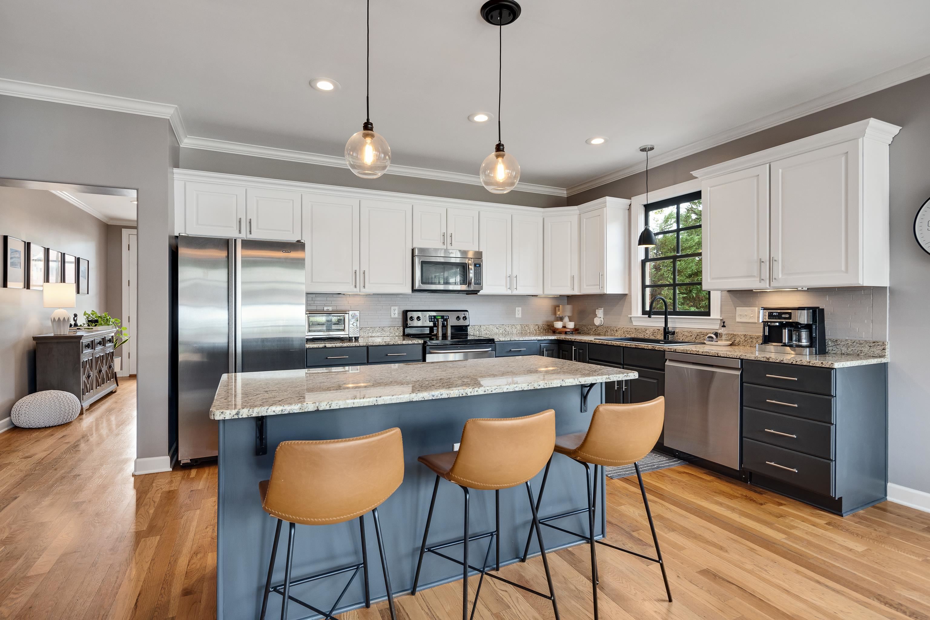 808 Deloach Lane Collierville, TN 38017 - Photo 8 of 40 a kitchen with stainless steel appliances granite countertop a sink a stove a refrigerator cabinets and chairs