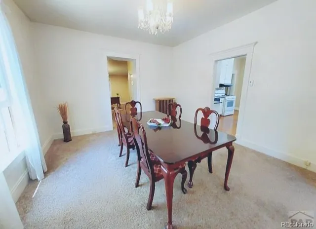 a view of a dining room with furniture and chandelier