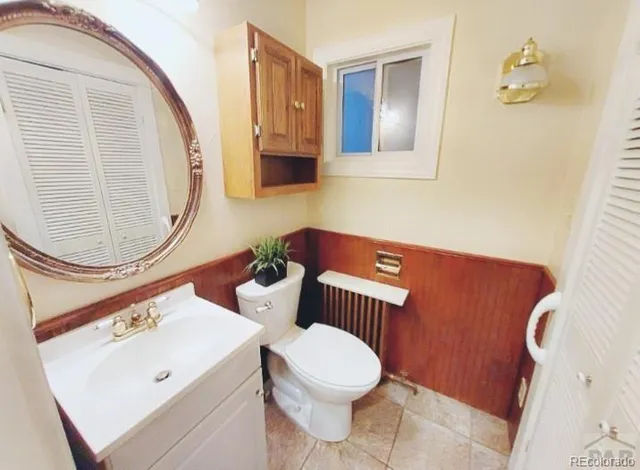a bathroom with a toilet a sink and a mirror