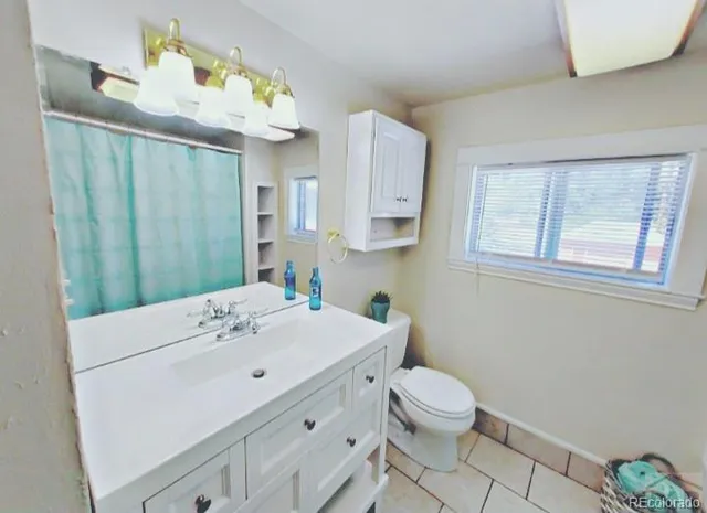 a bathroom with a sink toilet and mirror
