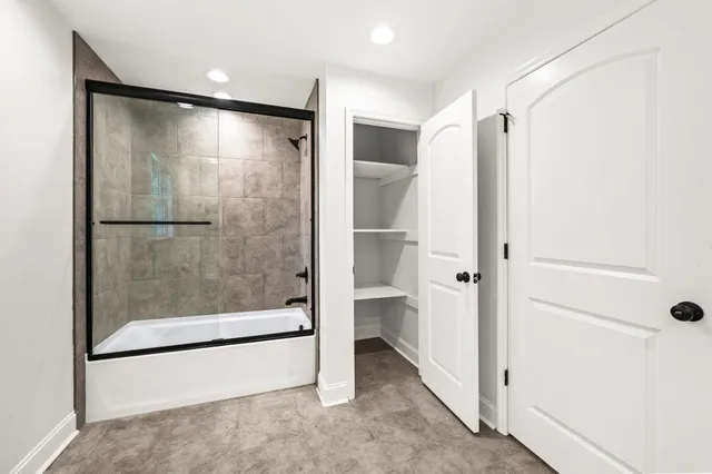 a bathroom with a glass shower door