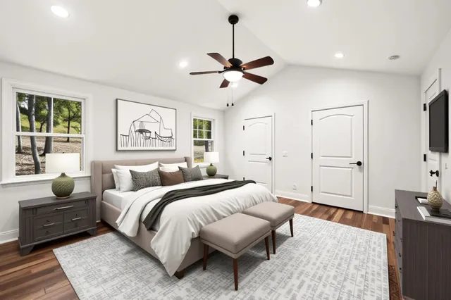 a bedroom with a bed a couch and a window