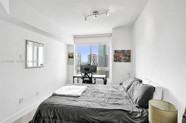 a bedroom with a bed and a chair