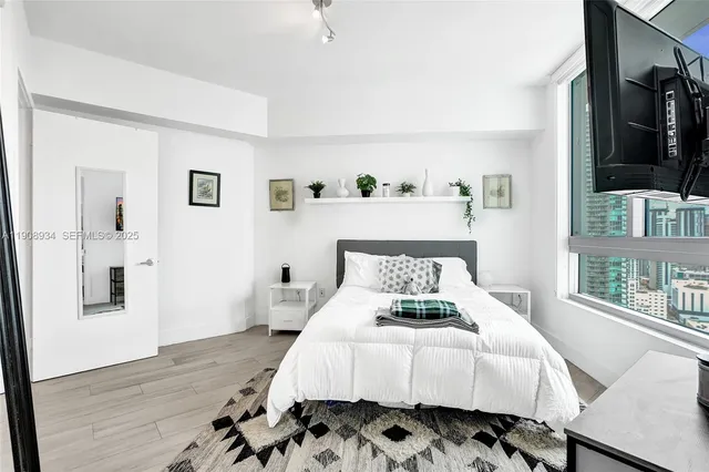 a bedroom with a bed and wooden floor