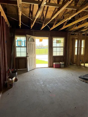 a view of empty room with furniture and a window