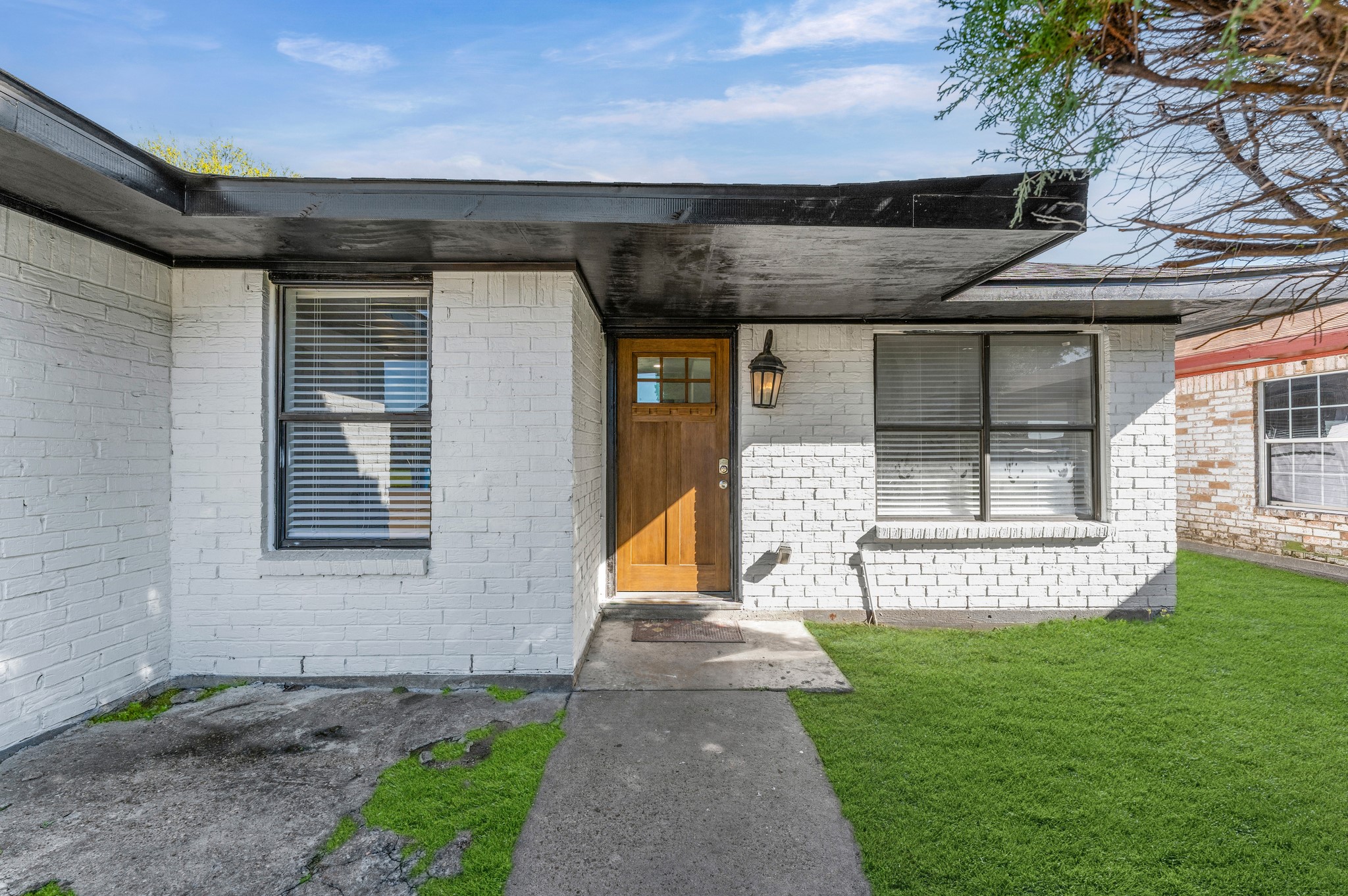 4519 Anice Street Houston, TX 77039 - Photo 1 of 25 a view of a house with a small yard and a large tree