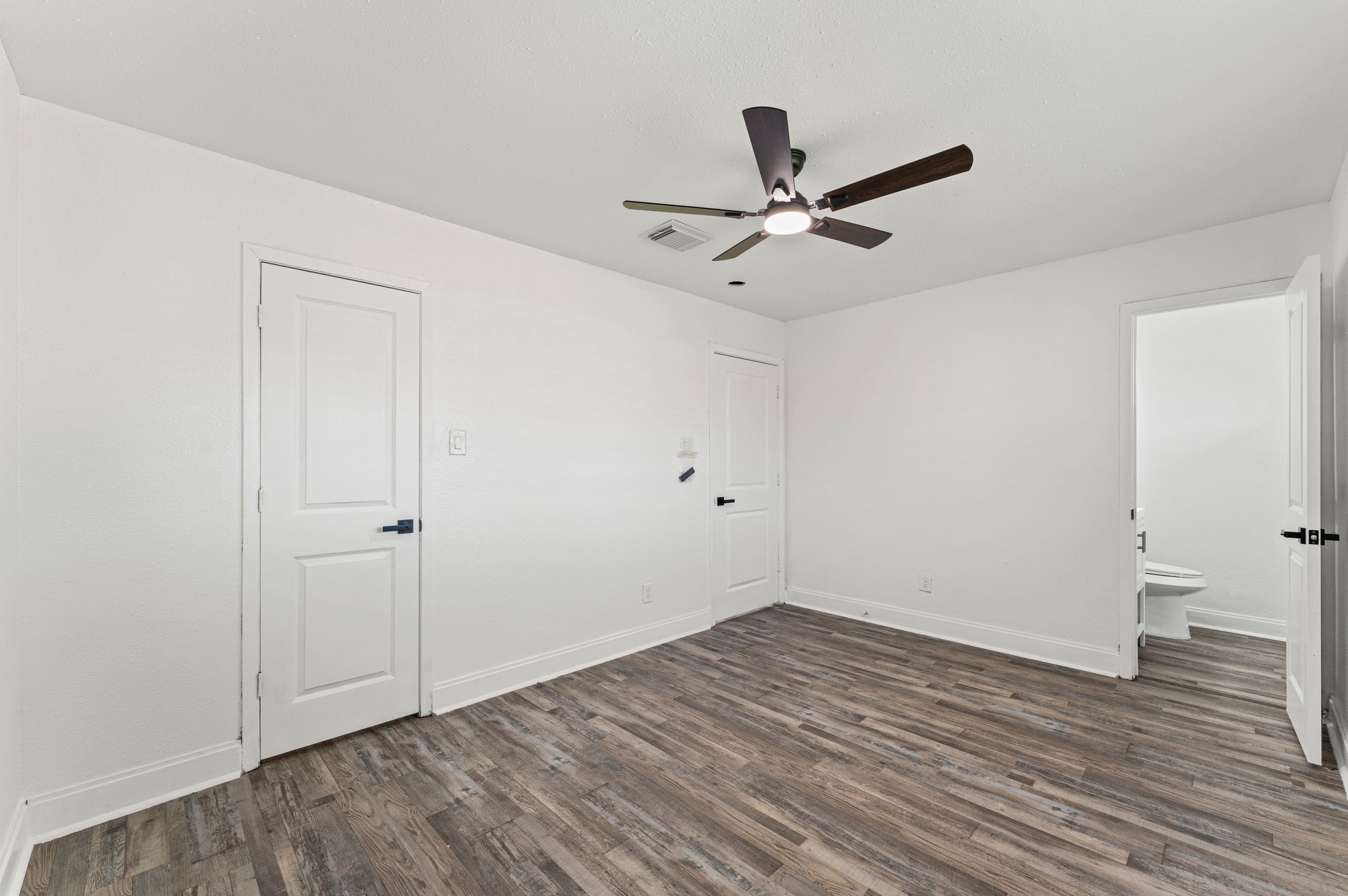 4519 Anice Street Houston, TX 77039 - Photo 15 of 25 an empty room with wooden floor and windows