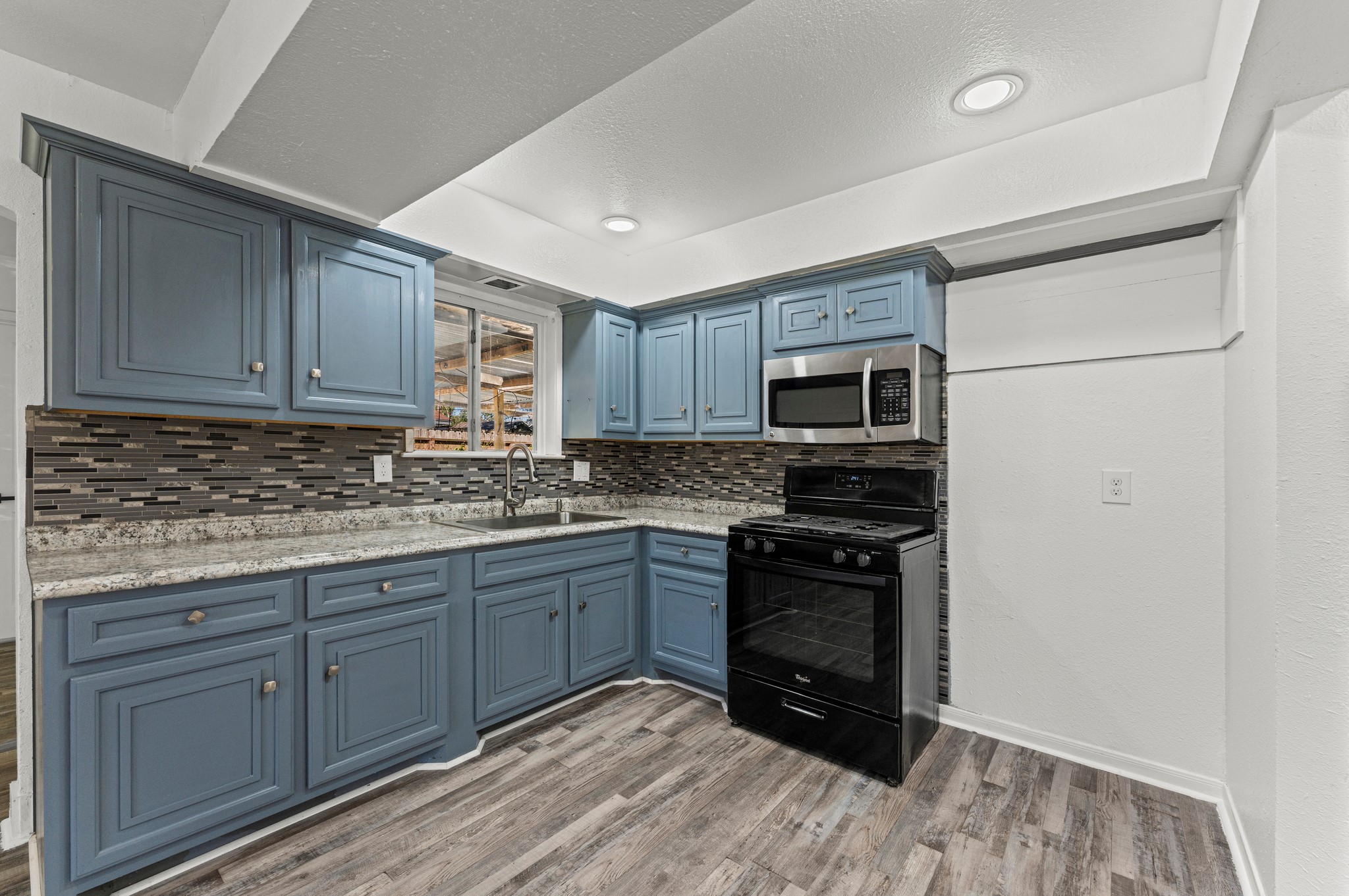 4519 Anice Street Houston, TX 77039 - Photo 2 of 25 a kitchen with wooden cabinets and stainless steel appliances