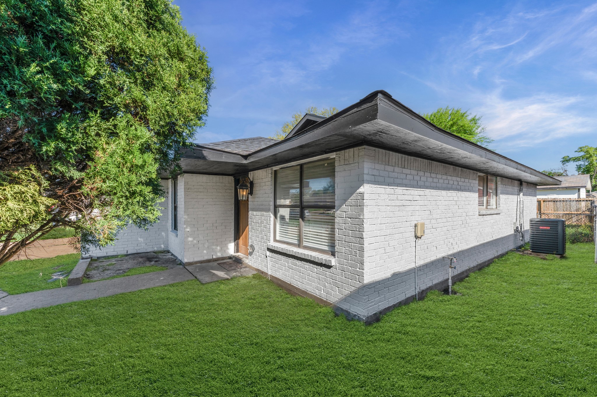 4519 Anice Street Houston, TX 77039 - Photo 25 of 25 a white house with a small yard and big trees with wooden fence