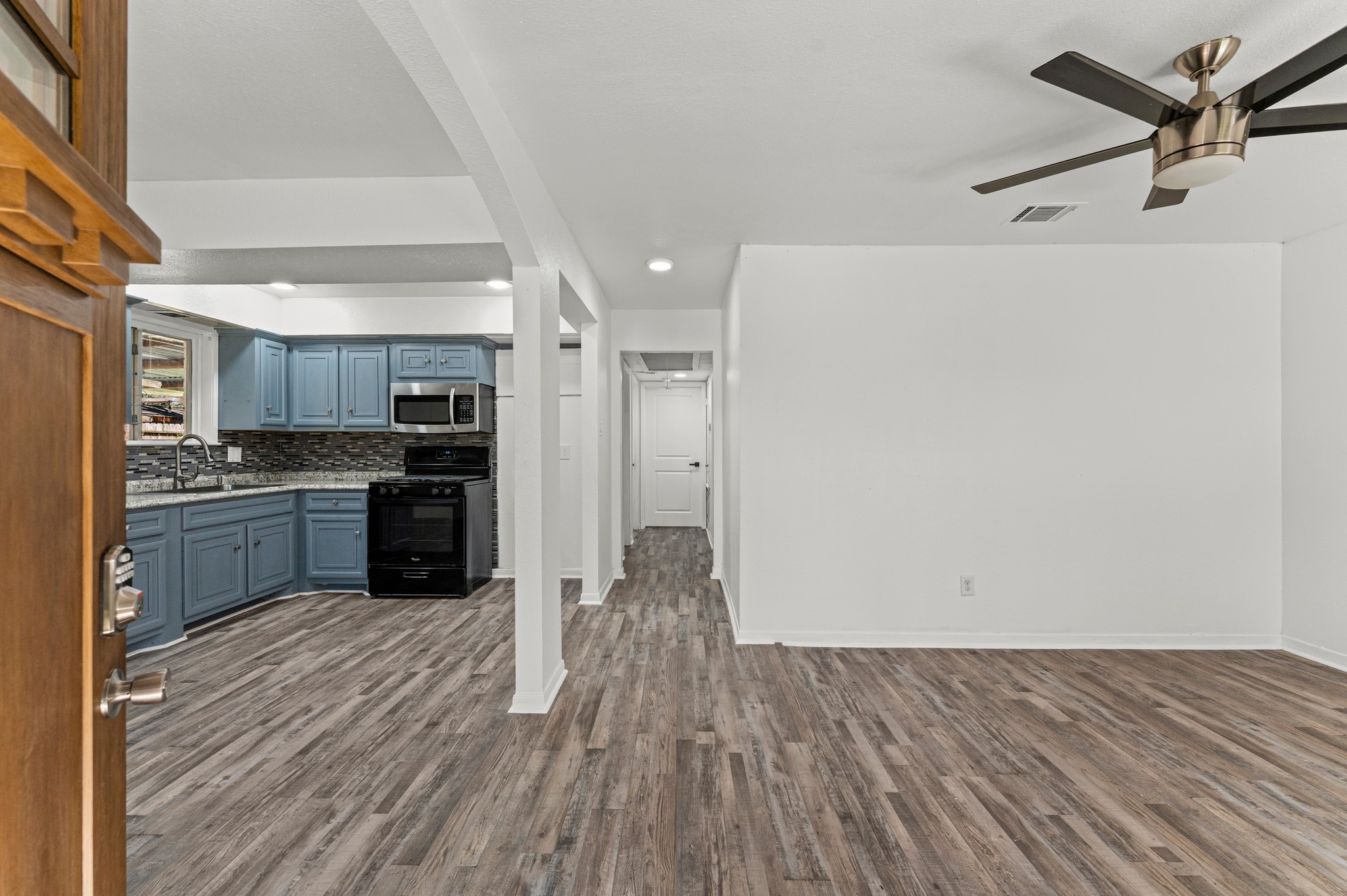 4519 Anice Street Houston, TX 77039 - Photo 4 of 25 a kitchen with a refrigerator and white cabinets