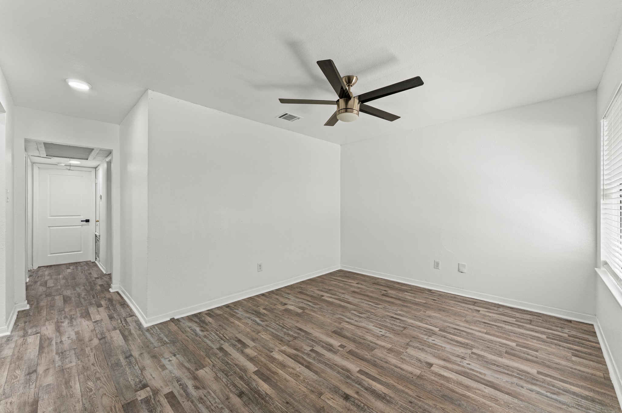 4519 Anice Street Houston, TX 77039 - Photo 6 of 25 a view of a big room with wooden floor and a ceiling fan