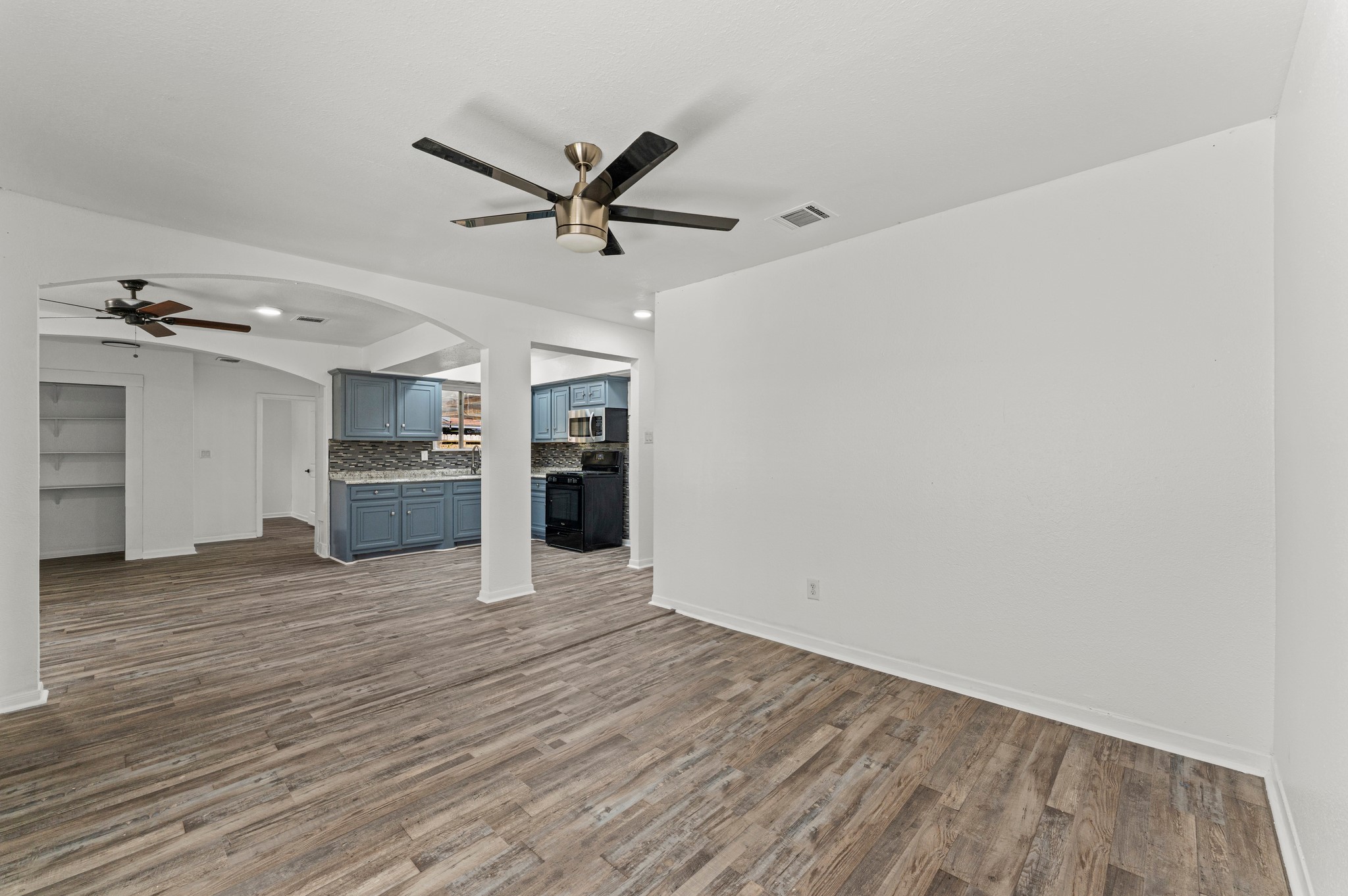 4519 Anice Street Houston, TX 77039 - Photo 7 of 25 an empty room with wooden floor closet and windows