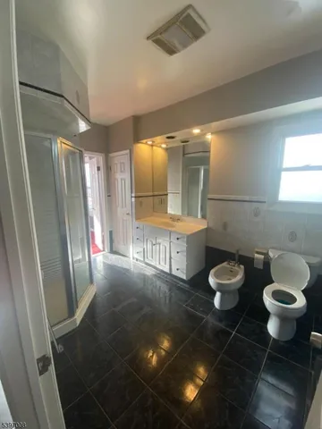 a bathroom with a sink a toilet and a shower