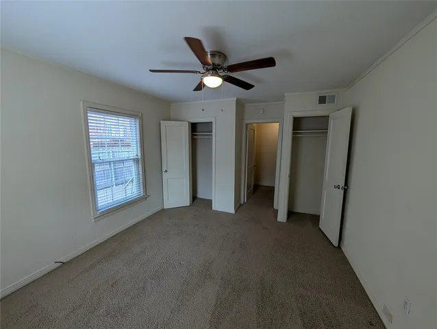 a view of a livingroom with a ceiling fan and window