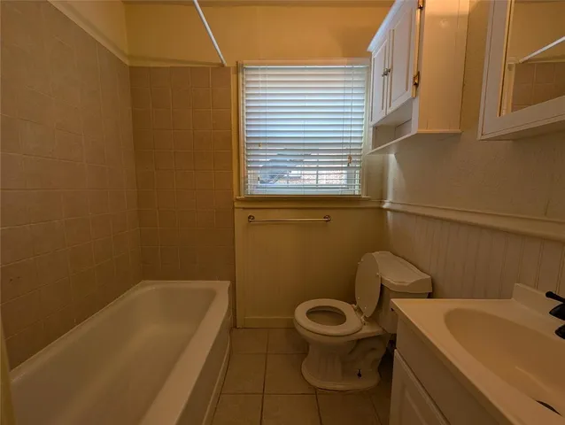 a bathroom with a sink a toilet and bathtub