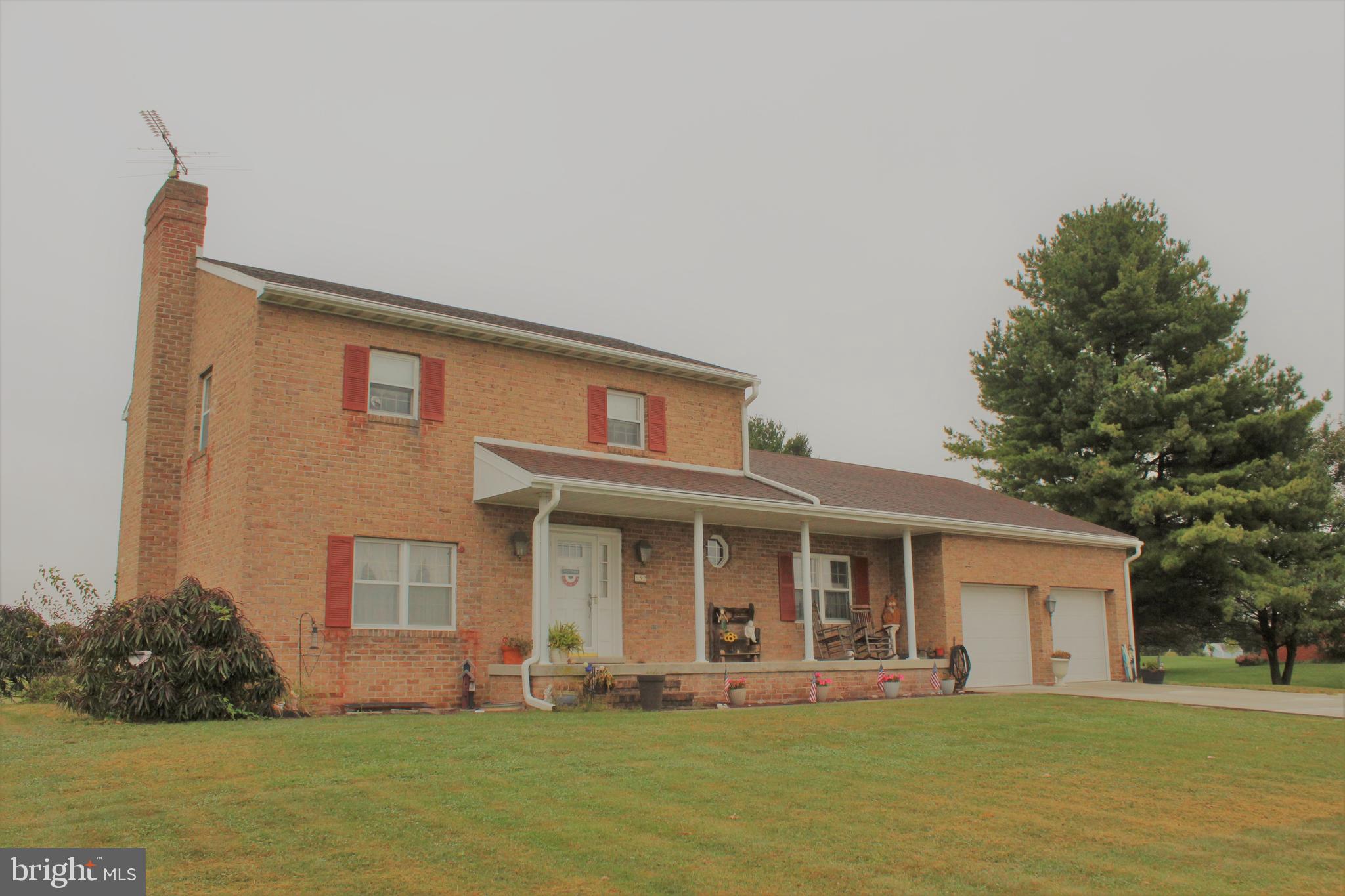 652 Cedar Ridge Road New Oxford, PA 17350 - Photo 1 of 17 a front view of a house with a yard and porch