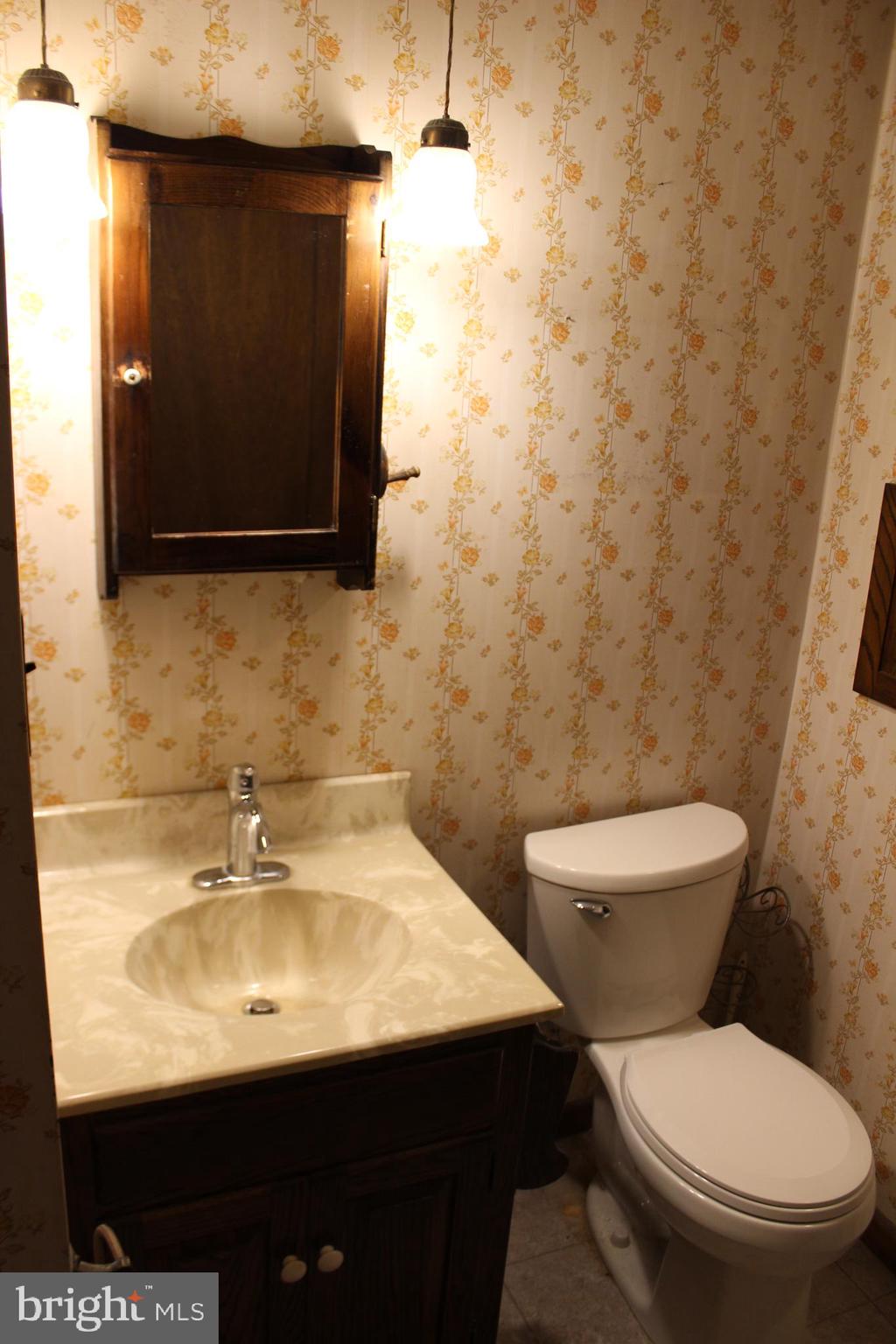 652 Cedar Ridge Road New Oxford, PA 17350 - Photo 11 of 17 a bathroom with a sink a toilet and mirror
