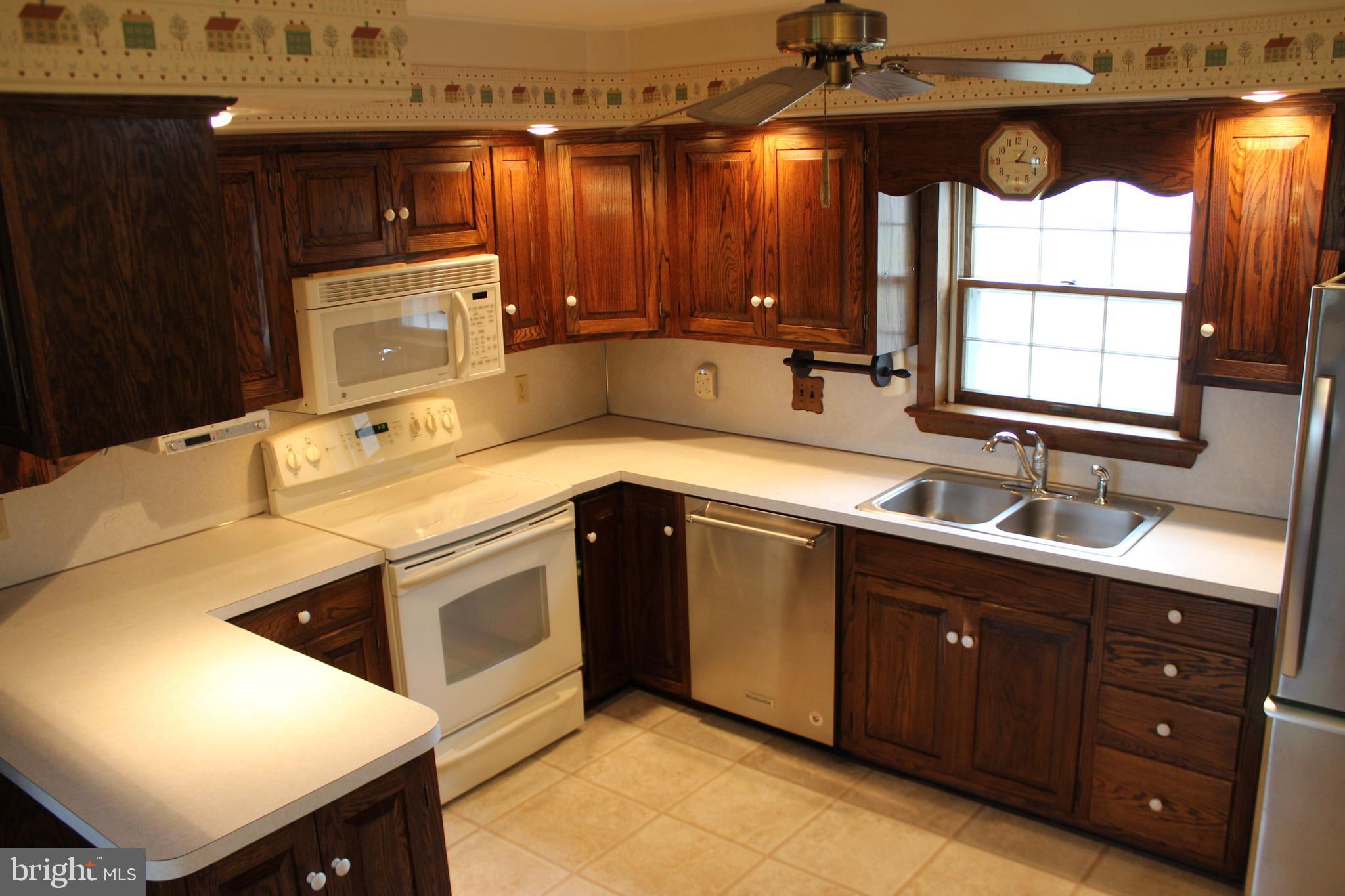 652 Cedar Ridge Road New Oxford, PA 17350 - Photo 7 of 17 a kitchen with stainless steel appliances granite countertop a sink a stove and a microwave