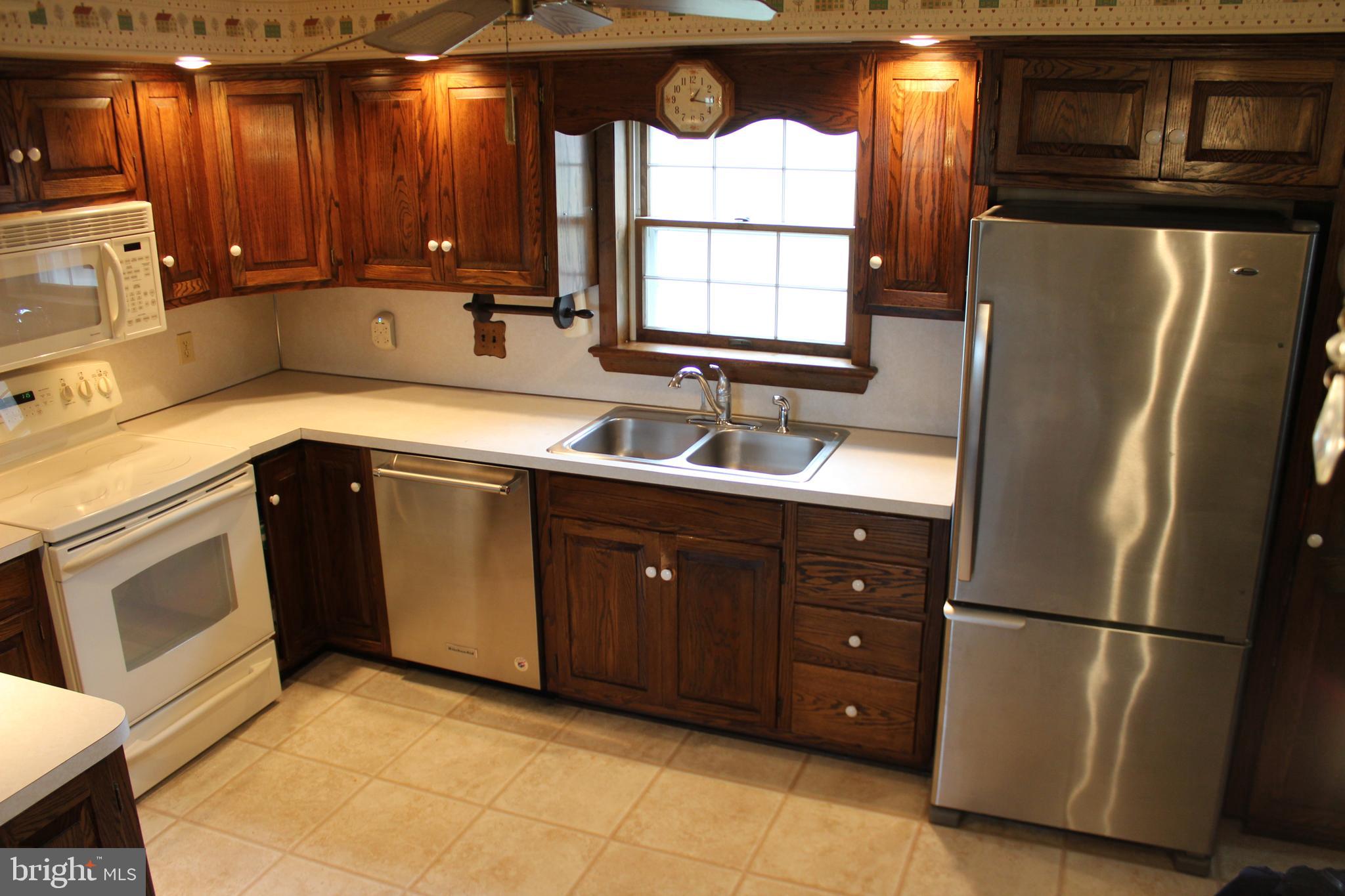 652 Cedar Ridge Road New Oxford, PA 17350 - Photo 8 of 17 a kitchen with a refrigerator sink and cabinets