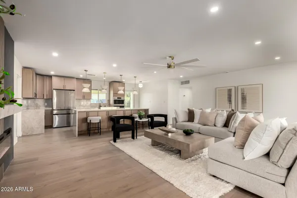 a living room with furniture and kitchen view