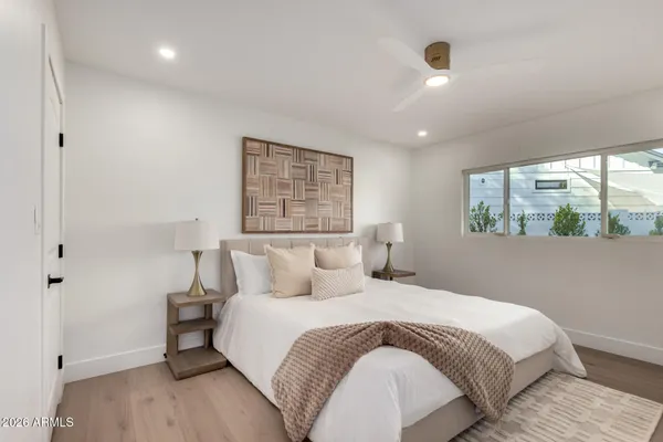 a bedroom with a large bed and a window