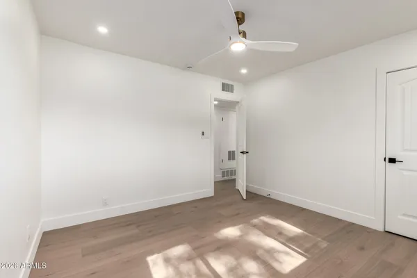 an empty room with wooden floor