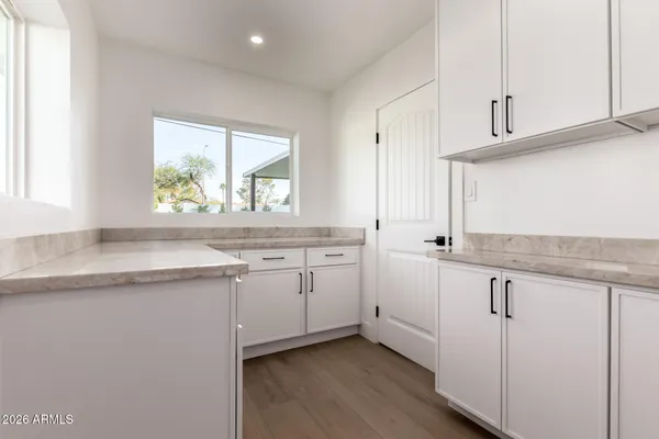a kitchen with granite countertop cabinets stainless steel appliances a sink and a window