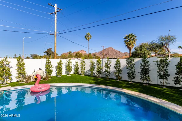 a view of a swimming pool with a yard